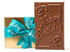 A large chooclate bar that has filigree decorations and the greeting "Happy Birthday" embossed in the chocolate mold. It comes in a gold box with an aqua ribbon with Happy Birthday printed on it.