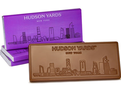 Hudson Yards skyline is molded into a rectangular Chocolate Bar. It comes wrapped in a purple skyline decorated wrapper.