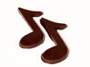 Three-dimensional chocolate molded music notes.
