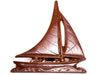A beautifully detailed molded chocolate sailboat skims across the waves.