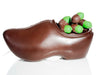 A molded chocolate Dutch-style wooden shoe is filled with bright green marzipan that is molded into bite-sized acorn shapes. The acorn “cap” is made by dipping the marzipan into 72% dark dairy-free chocolate.