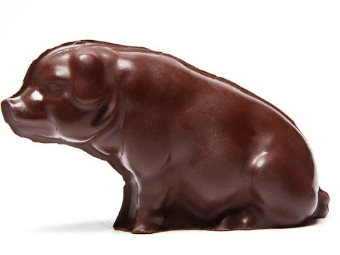 A sitting molded chocolate pig.