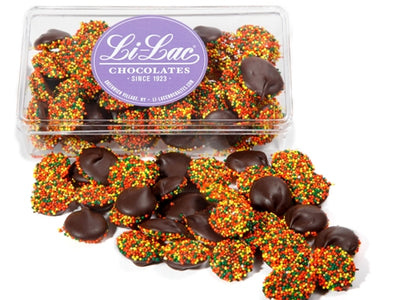 Thanksgiving colored Nonpareils in a clear box with a Li-Lac Choclate round sticker on the lid. 