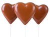 Molded chocolate Hearts are on a lolly stick.