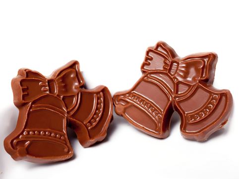 Molded chocolate wedding bells held together with a chocolate ribbon.