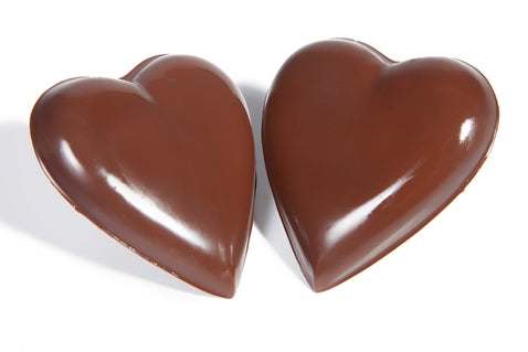 Two smooth, rounded chocolate molded hearts.