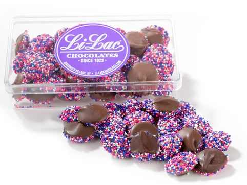 Chocolate Lilac nonpareils sit inside a clear box.